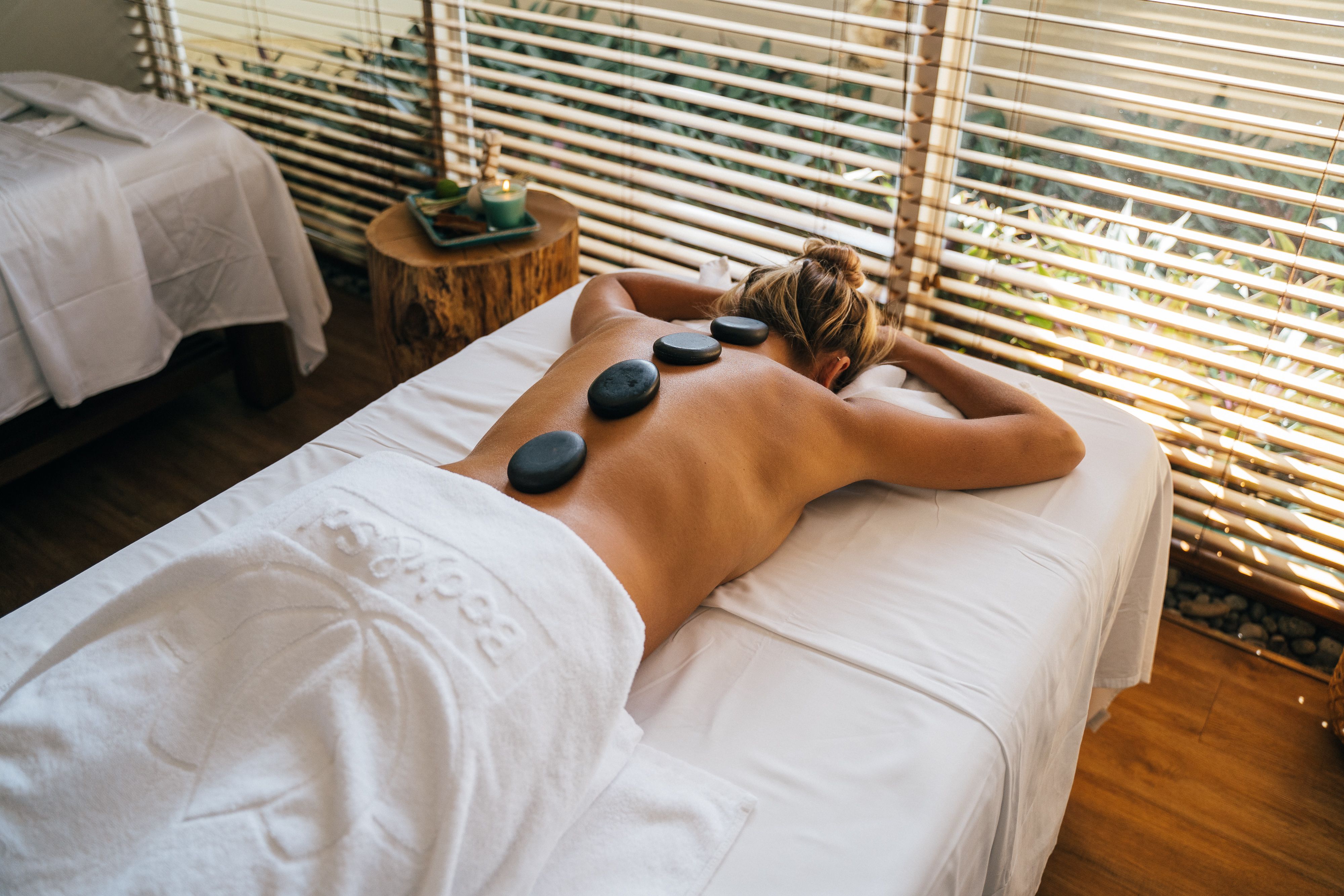 Hot stone therapy in a serene treatment room